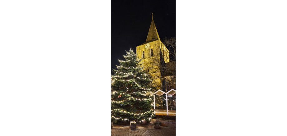 Illuminated church with Christmas tree